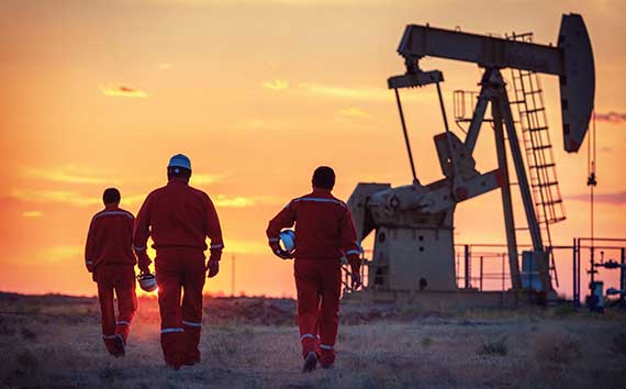 Oil and Gas Companies Workers in Front of Pump